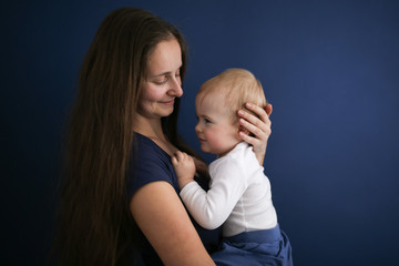 Cute Caucasian mom with long hair with baby