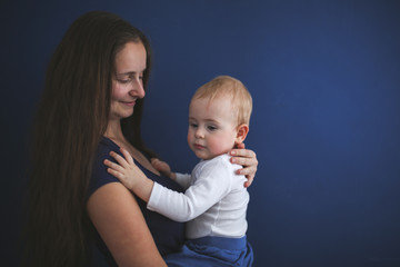 Mom and son baby together on blue background