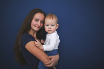 Mom and son baby together on blue background