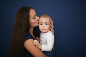 Cute Caucasian mom with long hair with baby