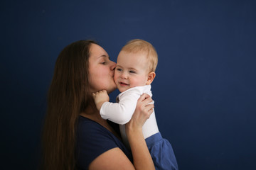 Mom and son baby together on blue background