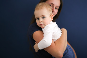 Mom and son baby together on blue background