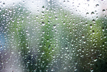 Tiny water drop on glass taking photo from inside of the car