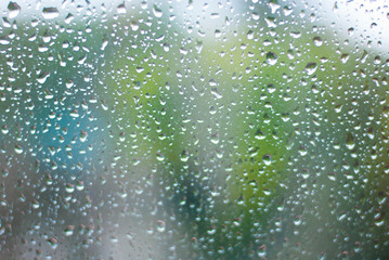 Tiny water drop on glass taking photo from inside of the car