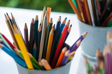 Fototapeta premium Sharp and blunt color pencils are put in bucket ready to be used in art workshop