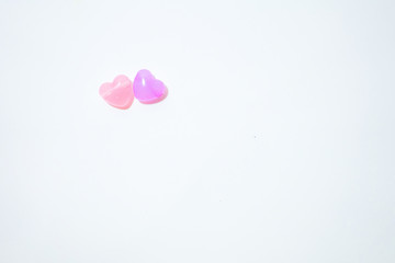 Colorful stones in heart shape on white background