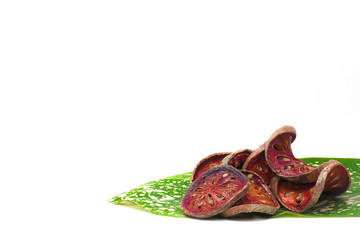 Fototapeta premium Dried slice Bale fruit with hard skin decorated with green plant leave on white background