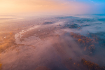 Early foggy morning. Aerial view of countryside and country road
