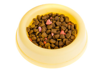 Yellow plastic bowl with dry pet food