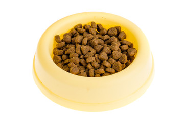 Yellow plastic bowl with dry pet food