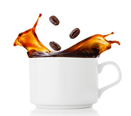 Coffee beans splash in cup of coffee