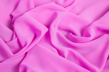 background of pink soft thin fabric lined with waves and folds