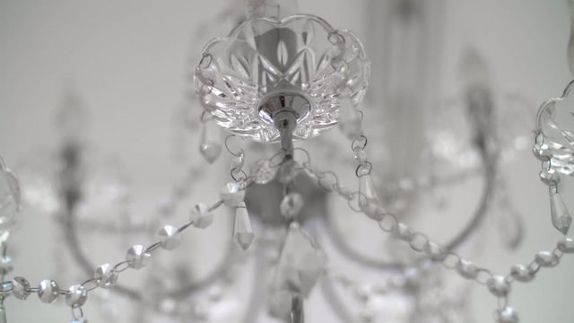 Crystals closeup. Crystal modern chandelier detail background. Hanging diamonds with blinking shining reflection. 