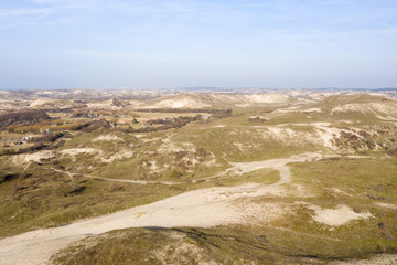 Dutch dunes by the sea from above in mystical late afternoon sun