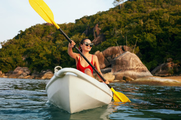 Summer Water Sport. Woman Traveling In Kayak Near Green Island
