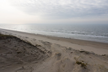 Dutch dunes by the sea from above in mystical late afternoon sun