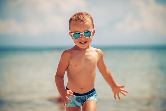 Cute little boy having fun on the beach
