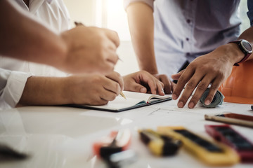 Teamwork of architect business people group working meeting in the office building plan design project. Construction engineering tools and structure concept