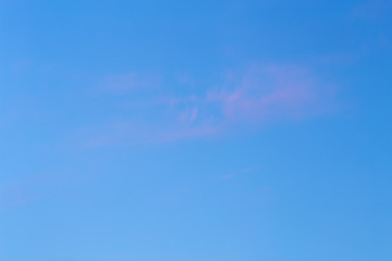 Background of sky with thin pink cloud at the golden hour.
