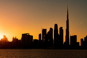 Fototapeta na wymiar Silhouette of Dubai cityscape with sunset