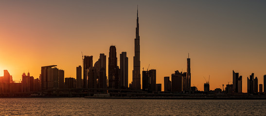 Obraz na płótnie Canvas Silhouette of Dubai cityscape at Magic Hour