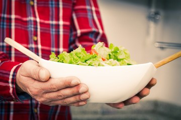 Obraz na płótnie Canvas man holding salad boll, diet and health concept