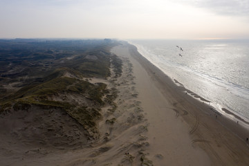 Dutch dunes by the sea from above in mystical late afternoon sun