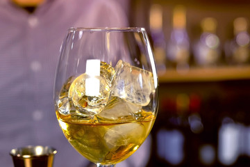 Prepare alcohol cocktail, liquor with eyes on wineglass.