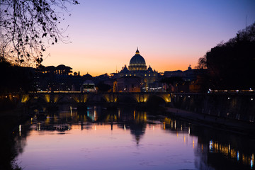 view from the tiber river of St. Peter's Basilica at sunset, Vatican, Rome, Italy