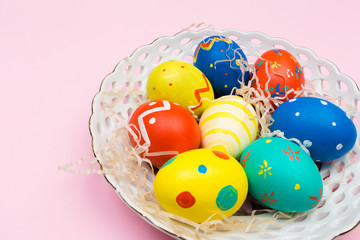 easter eggs on plate on pink background