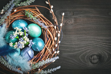 Happy Easter. Congratulatory easter background. Easter eggs and flowers. Background with copy space. Selective focus.