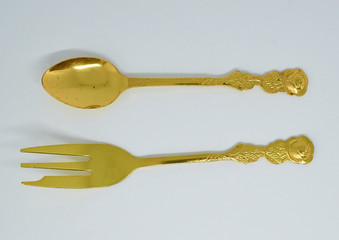 old gilded spoon and fork lie next each other