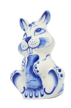 ceramic statuette hare with carrot Gzhel isolated white background