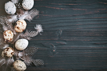 Quail eggs on old wooden background. Happy Easter. Top view. Free copy space. Selective focus.