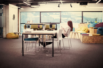 redhead businesswoman using mobile phone at office