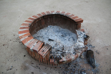 Broken fire pit with ashes