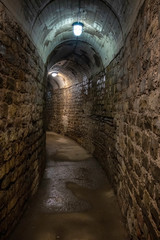 Fototapeta na wymiar An ancient underground tunnel with lights 