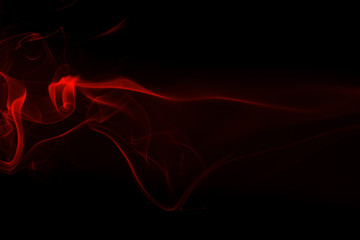 Movement of red smoke on black background