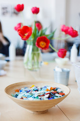 Plate with colored ceramic mosaic on the table in the creative workshop.
