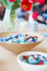 Plate with colored ceramic mosaic on the table in the creative workshop.