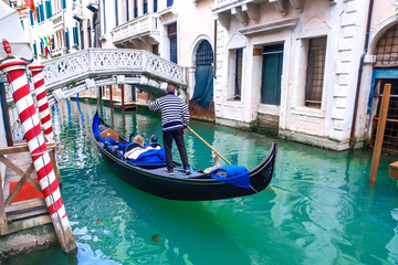Fototapeta na wymiar Venetian gondolier gondola through of Venice. Italy