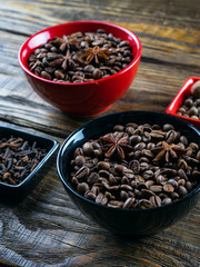 Coffee beans in a container, cinnamon, nutmeg and cloves.