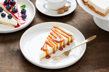 New York cheesecake with caramel sauce on a plate .
