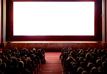 People in the cinema auditorium with empty white screen. - obrazy, fototapety, plakaty