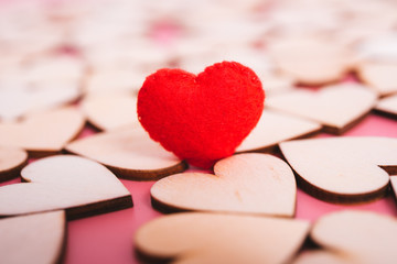 Red hearts stand on pink background