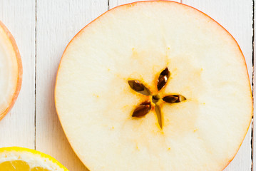 Sliced fruits, vegetables on white wooden table