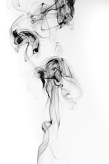 Abstract black smoke swirls and curves on white background