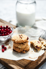 Pumpkin, oat cookies with cranberries on wooden background