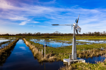 A windmill in dutch farmland, rural scene. Near Den Bosch, Noord-Brabant, Netherlands.