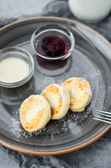 Curd pancakes with berry jam and sour cream